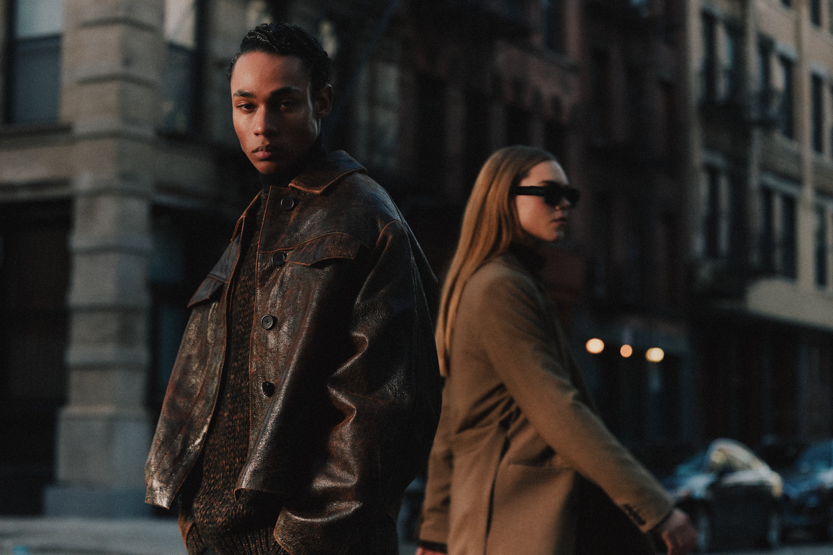 Man and woman wearing earth-toned outfits from Minimum in New York.