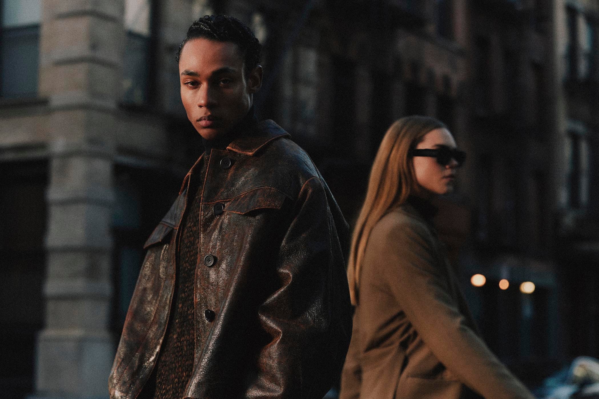 Man and woman wearing earth-toned outfits from Minimum in New York.