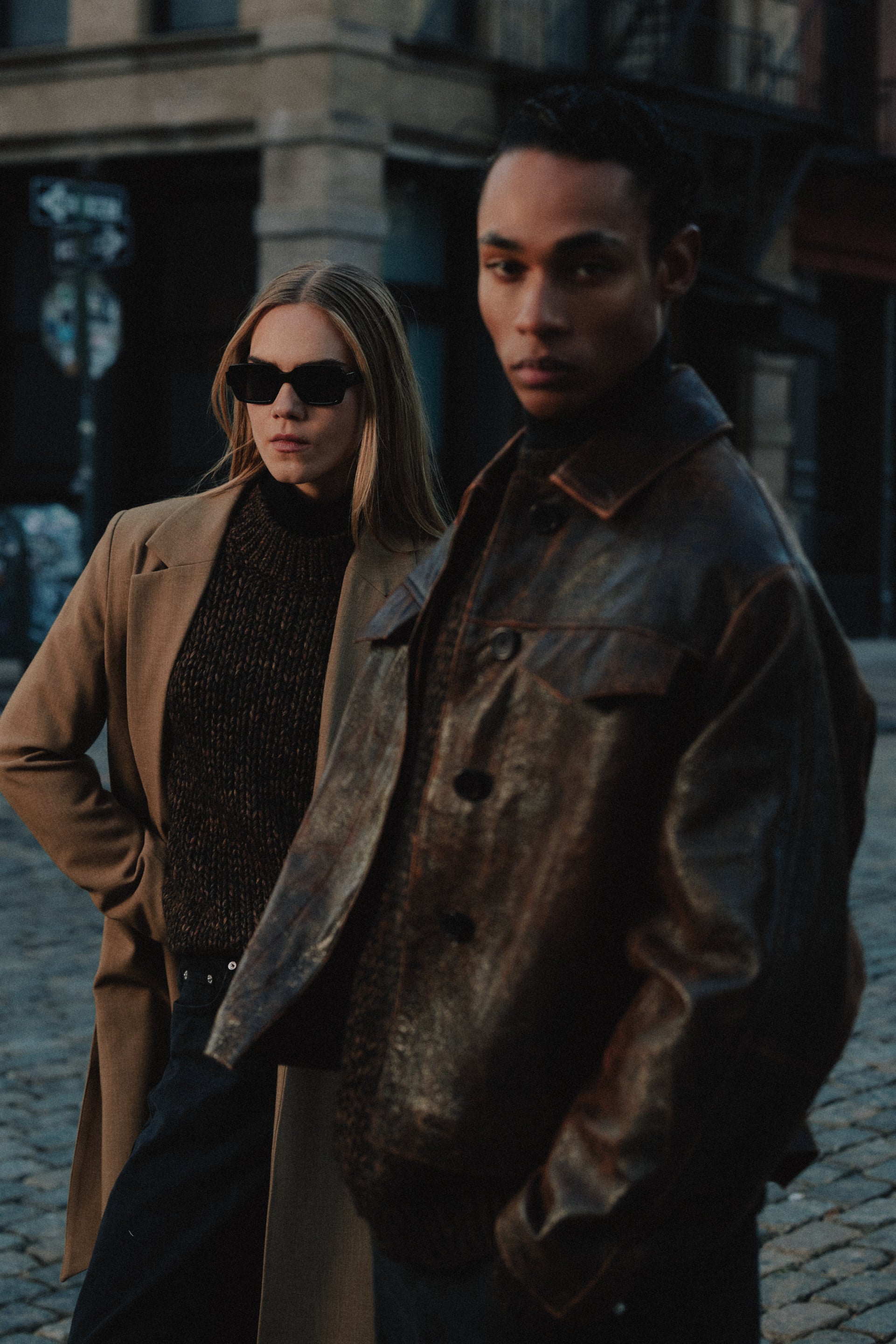 Man and woman wearing earth-toned outfits from Minimum in New York.